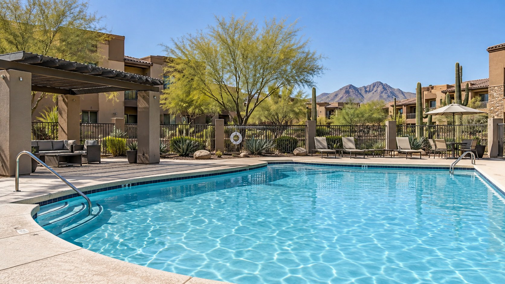 Commercial swimming pool at an Arizona apartment community with desert landscaping and mountains
